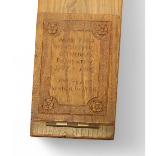 387 - A folding wooden book rest, one end engraved ‘Wood from Winchester Cathedral Foundation 1202 - 1906 ... 