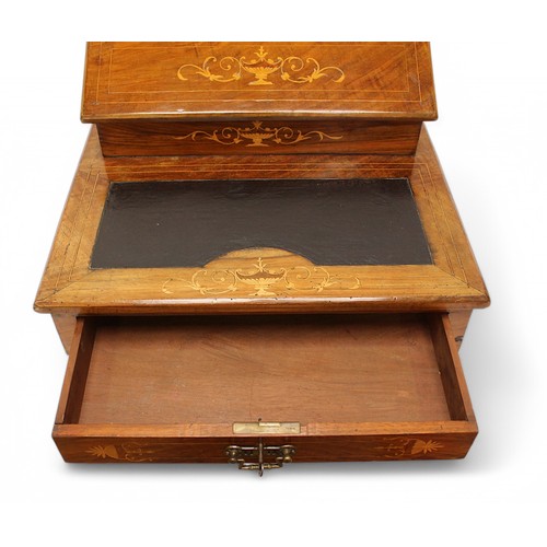 565 - An Edwardian inlaid mahogany table-top writing desk, the raised top enclosing a compartmented interi... 