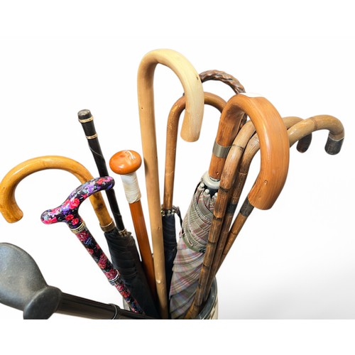 395 - A collection of eleven various walking sticks and umbrellas, including four silver-collared and silv... 