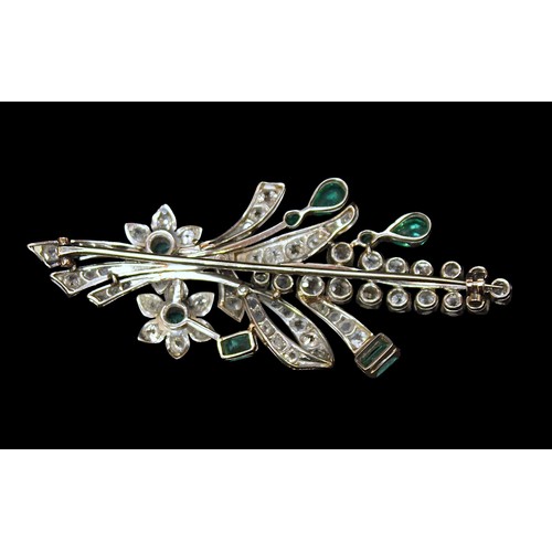 229 - A 1930s Platinum, Diamond and Emerald brooch, modelled as a floral spray, claw-set and milligrain se... 