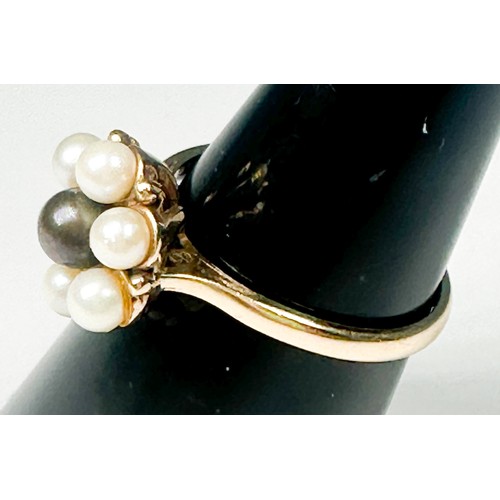 240 - A 9ct yellow gold dress ring, set with a single black cultured pearl to the centre, surrounded by si... 