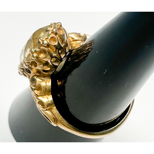 251 - A 9ct gold dress ring, claw-set in a foliate design shank, with a large faceted citrine, measuring a... 