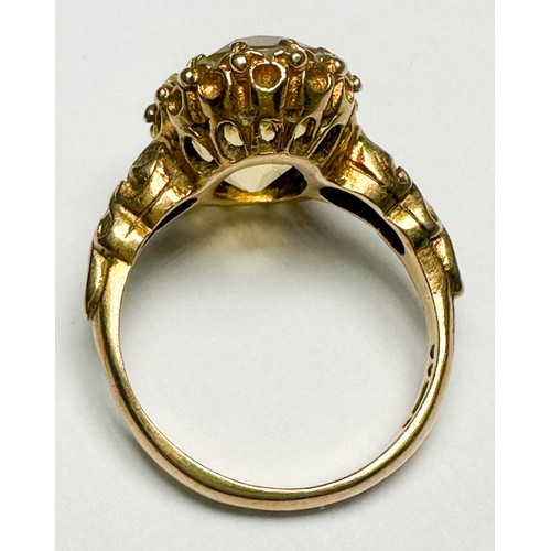 251 - A 9ct gold dress ring, claw-set in a foliate design shank, with a large faceted citrine, measuring a... 