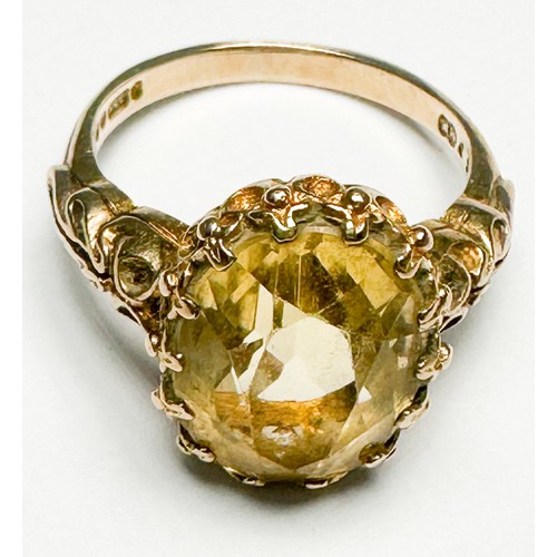 251 - A 9ct gold dress ring, claw-set in a foliate design shank, with a large faceted citrine, measuring a... 