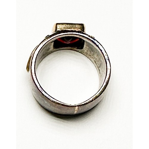 262 - A 9ct gold and silver dress ring, bezel set with a emerald cut garnet, measuring approximately 10 x ... 