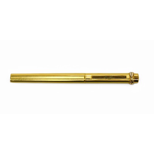 402 - A Must de Cartier ‘Stylo’ ballpoint pen, the gold-plated body and cap with engine turned decoration ... 