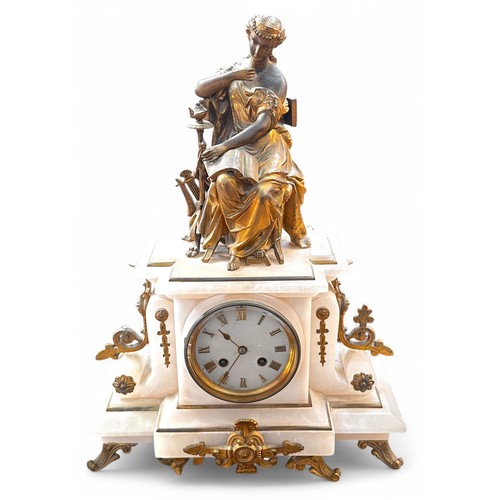 467 - A White Onyx mantel clock with eight-day movement striking a bell, surmounted by a classical dressed... 