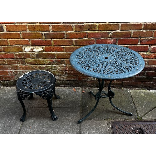 561 - A thirteen-piece painted aluminium pierced garden set including chairs, a bench and three circular t... 