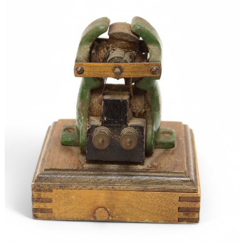 457 - A late 19th or early 20th Century bipolar toy electric motor, green painted cast iron mounted on woo... 