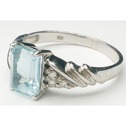 269 - An 18ct white gold dress ring, four-claw set with an emerald-cut aquamarine, measuring approx 8 x 6m... 