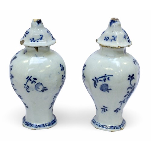 117 - A pair of late 18th / early 19th century Dutch Delft pottery vases and covers by the De Lampetkan fa... 