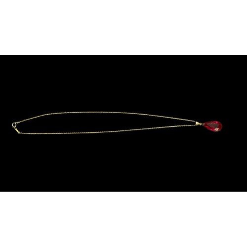 277 - A 14ct gold necklace chain and pendant suspended with a faceted pear-shaped ruby coloured stone.