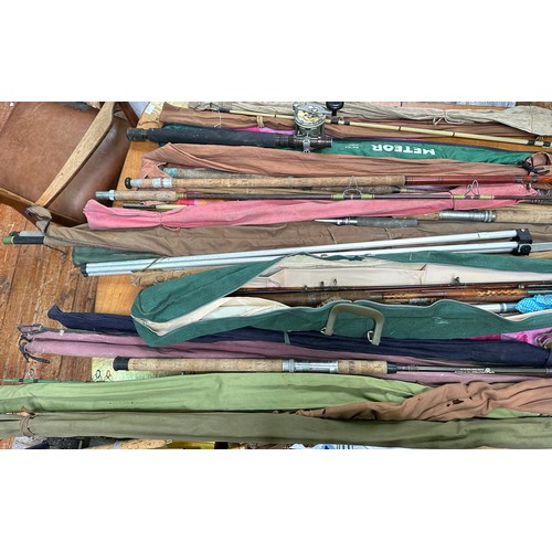 430 - A collection of various fishing rods with cases, longest measures 184cm.