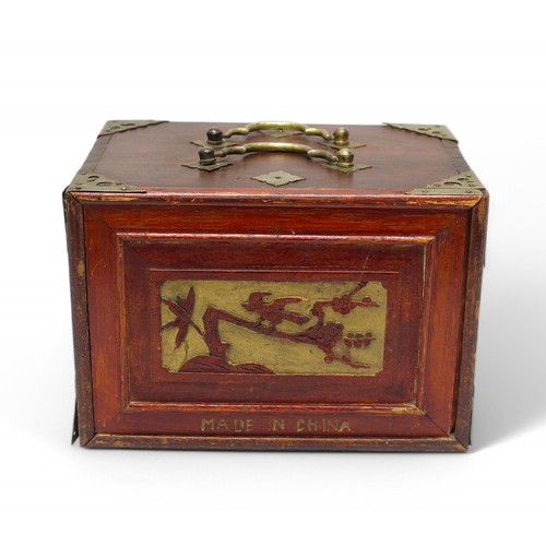 410 - A Chinese mah-jong set with bone and bamboo tiles, in four-drawer chest.