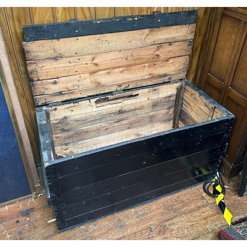 583 - A black painted wooden trunk, with planked top and sides, 110cm long, together with a smaller black ... 