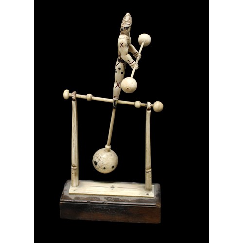 416 - A rare 19th century French bone prisoner of war figure modelled as a tightrope walker holding a bala... 