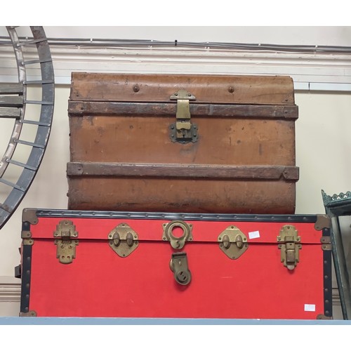 A red metal bound steamer trunk, together with a brown wood effect ...