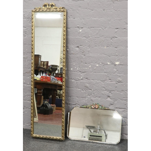 62 - An ornate gilt framed full length mirror along with a bevel edge wall mirror with floral pediment.