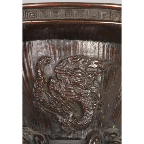 187 - A Japanese Meiji period bronze koro base of quatrefoil form. Decorated with a dragon and a kirin and... 