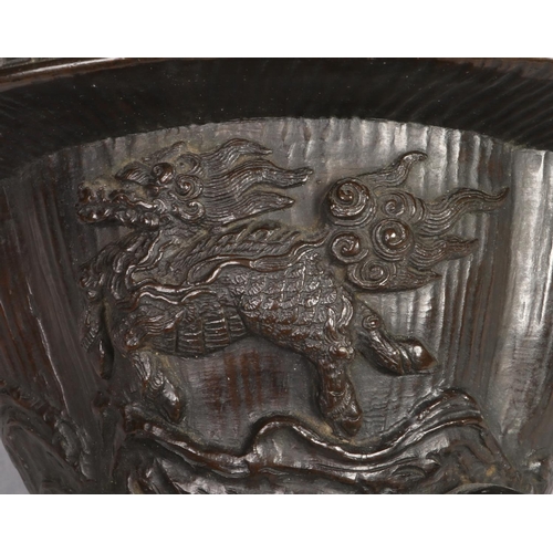 187 - A Japanese Meiji period bronze koro base of quatrefoil form. Decorated with a dragon and a kirin and... 