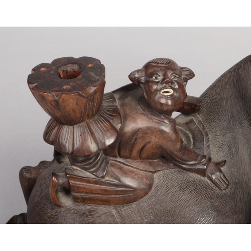 202 - A 19th century Chinese carved hardwood sculpture of a water buffalo with a young boy riding upon its... 