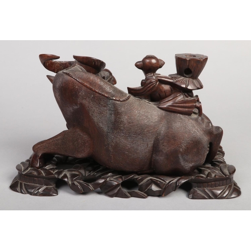 202 - A 19th century Chinese carved hardwood sculpture of a water buffalo with a young boy riding upon its... 