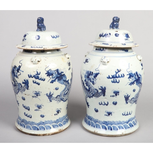 203 - A large pair of Chinese blue and white decorative baluster shaped floor vases with domed covers. Eac... 