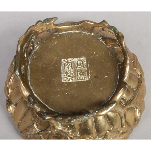 206 - A Chinese polished bronze fluted bowl. Modelled in the form of a lotus flower and raised on branch m... 