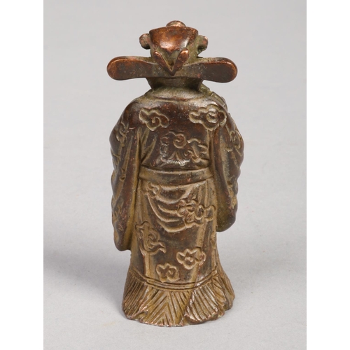 216 - A Chinese miniature bronze figure of a sage. Wearing a hat and dressed in flowing robes decorated wi... 