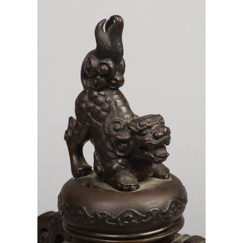 220 - A Japanese Meiji period bronze censor. With dog of fo finial to the pierced cover, relief panels dec... 