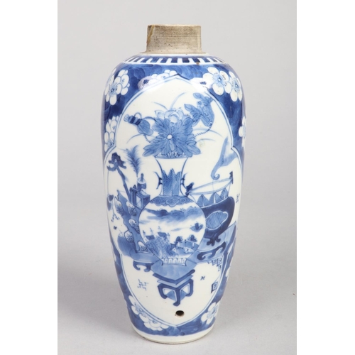 221 - A Chinese Kangxi (1662-1722) blue and white vase. Painted in underglaze blue with two shaped panels ... 