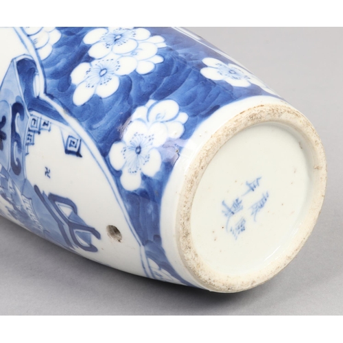 221 - A Chinese Kangxi (1662-1722) blue and white vase. Painted in underglaze blue with two shaped panels ... 