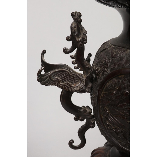 228 - A Japanese Meiji period twin handled temple censor on wooden stand.  With scrolling dragon handles a... 