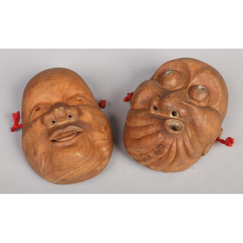 233 - A pair of Japanese Taisho period carved wooden Noh (theatre) masks. Each forming a different express... 