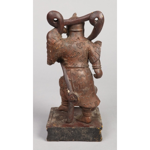 238 - A 19th century Chinese carved softwood and lacquered statue formed as a warrior, 27.5cm.