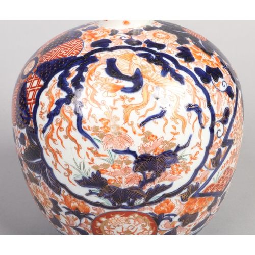 247 - A Japanese Meiji period large Imari bottle vase. Decorated with panels of birds and two pheonix, 46c... 