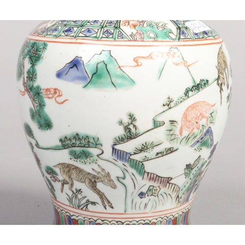 249 - A 20th century Chinese baluster ginger jar and cover. Decorated in the famille verte style with a la... 