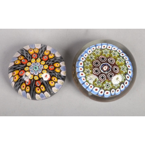 52 - Two polychrome split cane glass paperweights. Largest 9cm diameter.