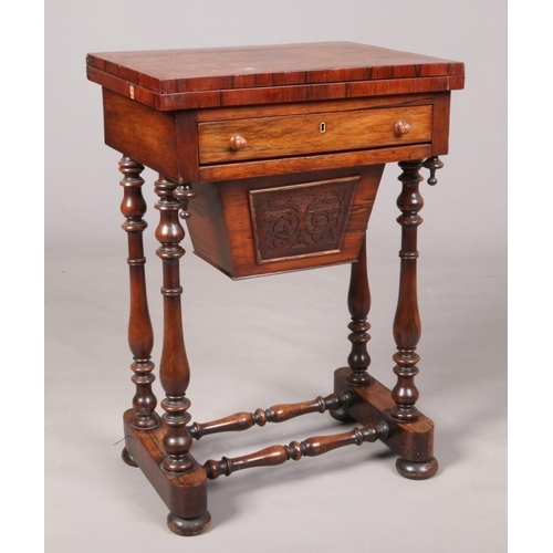 697 - A Victorian rosewood work table raised on turned supports. With fold over inlaid gaming top, 75cm hi... 