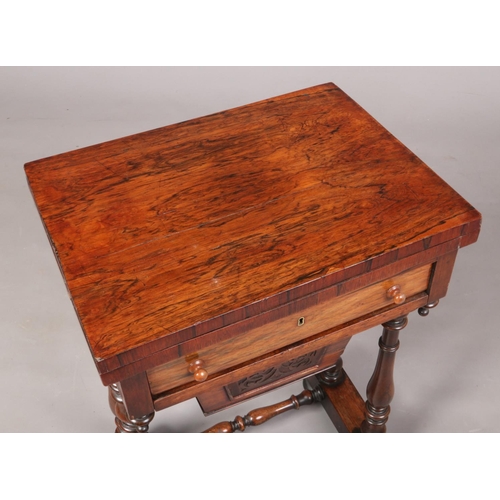 697 - A Victorian rosewood work table raised on turned supports. With fold over inlaid gaming top, 75cm hi... 