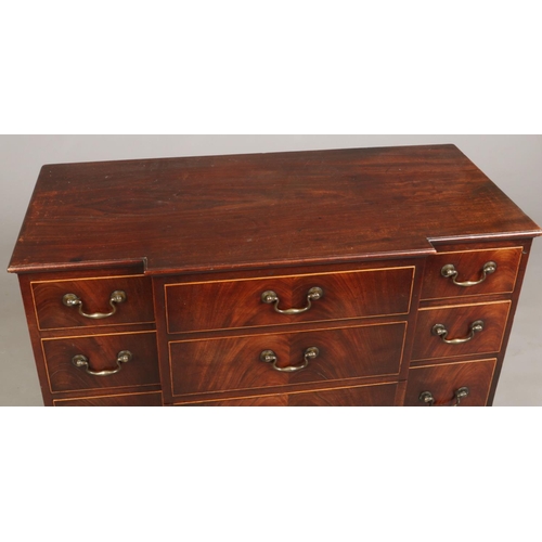 698 - A George III mahogany breakfront dressing chest. Oak lined, with bronze drop handles and raised on r... 