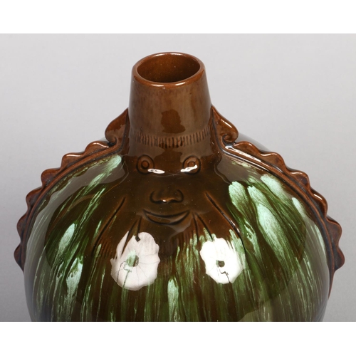 115 - A Linthorpe pottery Aztec style bottle vase designed by Dr. Christopher Dresser. With reeded mouldin... 