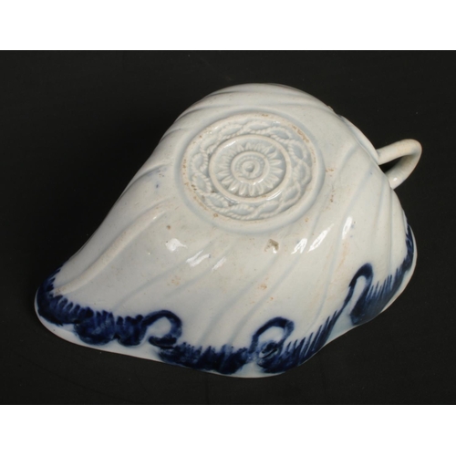 131 - A late 18th century pearlware leaf moulded butter boat. With scrolling stalk handle, edged in underg... 