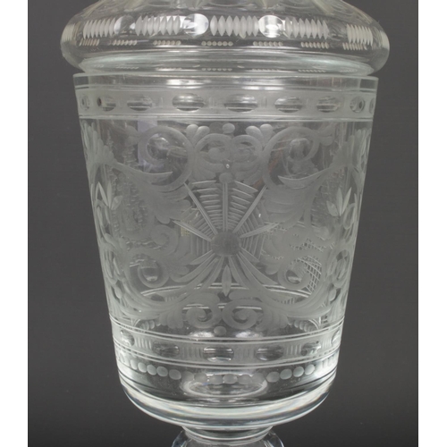 78 - A 20th century Bohemian glass goblet and cover. Etched with a panel depicting a lady playing tennis,... 