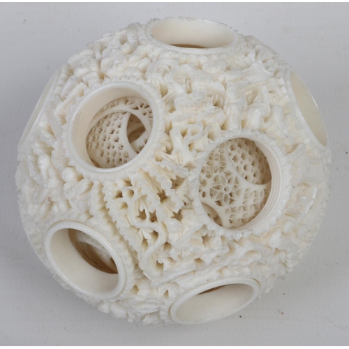 183 - A late 19th / early 20th century Cantonese carved ivory puzzle ball on stand. The stand is formed as... 