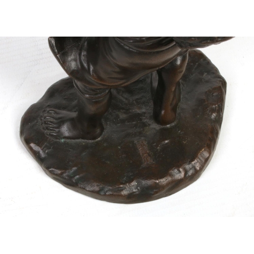 227 - A Japanese Meiji period patinated bronze figure of a farmer. Modelled pulling his coolie hat firmly ... 