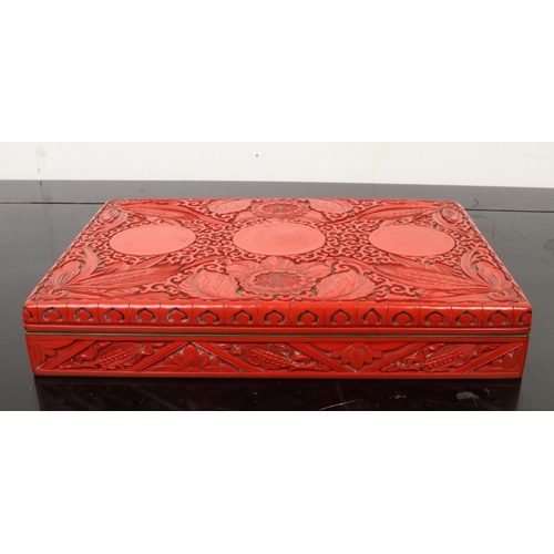 201 - A Chinese cinnabar lacquer rectangular box and cover. Decorated in relief with peonies and ears of c... 