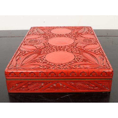 201 - A Chinese cinnabar lacquer rectangular box and cover. Decorated in relief with peonies and ears of c... 