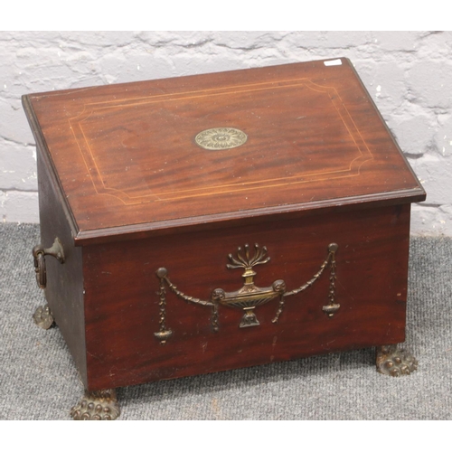 572 - An Edwardian mahogany coal box with string inlay, brass patera, loop handles and raised on paw feet.