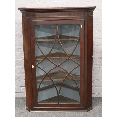 574 - A George III mahogany astrigal glazed corner cupboard.